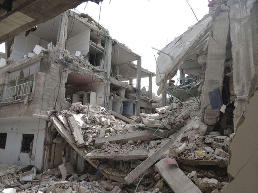 A view shows buildings damaged by what activists say were missiles fired by Syrian Air Force fighter jets