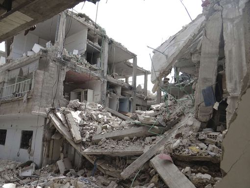 Damage: Fighting in Syria has left many areas in ruins (file picture) A view shows buildings damaged by what activists say were missiles fired by Syrian Air Force fighter jets