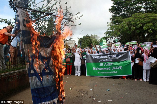 Israeli PM Benjamin Netanyahu became a central figure in the response to the Paris terror attacks after four Jewish shoppers were killed by one of the Islamic fanatics. Here, a tarpaulin with his image and the Israeli flag is torched by Filipinos over the decision to publish a cartoon of Mohammed on Charlie Hebdo