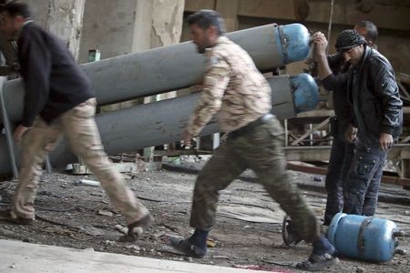 Shamiyah Front fighters prepare locally made shells before firing them towards forces loyal to Syria's President Bashar Al-Assad in the old city of Aleppo