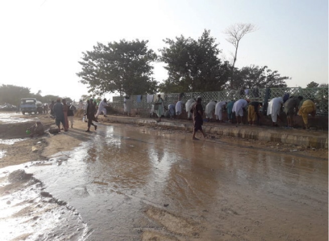 Water stands at the H-9 protest venue and the road adjacent to it. — Photos by Tanveer Shahzad and Kashif Abbasi