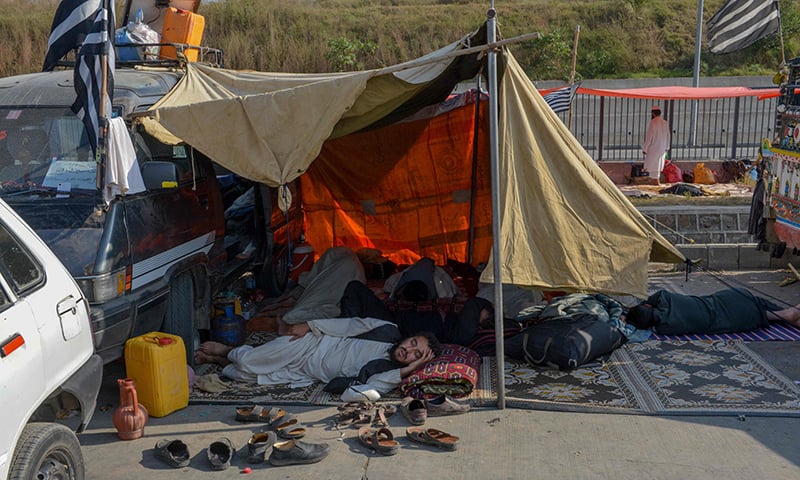 Participants rest during the ongoing 'Azadi March' in Islamabad on November 3, 2019. — AFP