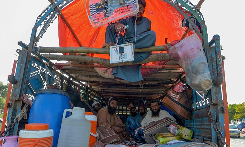 Opposition activists look on as they rest in a truck during the 'Azadi March' in Islamabad on November 3, 2019. — AFP