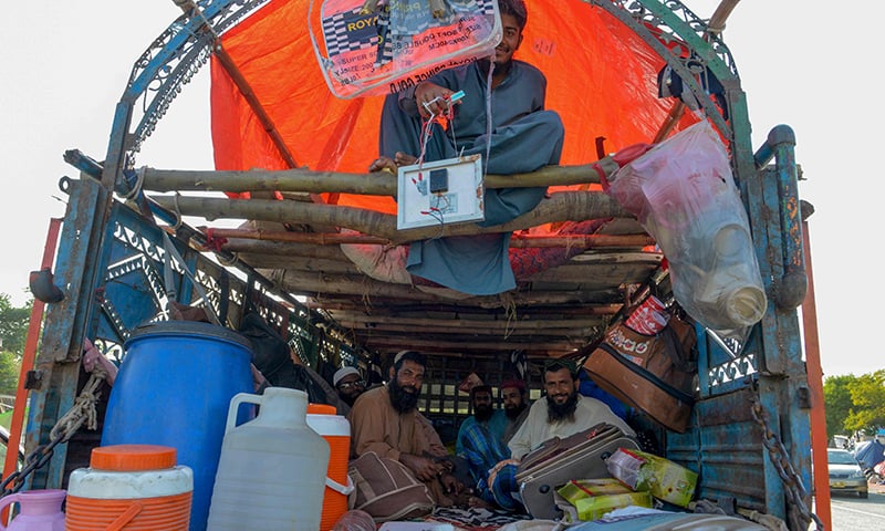 Opposition activists look on as they rest in a truck during the 'Azadi March' in Islamabad on November 3, 2019.  AFP